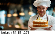 Повар в белом колпаке держит в руках торт с коржами. A cook in a white hat holds a cake with layers in his hands. Стоковое AI-изображение, AI-художник Смирнова Светлана / Фотобанк Лори