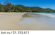 A beautiful tropical beach without people. The waves of the aquamarine ocean foam and spread over the sand. A green hill against a clear blue sky. Copy space. Malaysia. Borneo. Kota Kinabalu. Стоковое фото, фотограф Вера Ивановна Кубарева / Фотобанк Лори