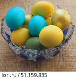 Colorful Easter eggs lie in a glass vase. Yellow, blue, green, Golden eggs. Стоковое фото, фотограф Олег Тараканов / Фотобанк Лори
