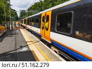 London Overground train at suburban station platform, orange livery, London, UK. Стоковое фото, фотограф Zydrius Tartenis / Фотобанк Лори