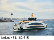 ISTANBUL, TURKEY - NOVEMBER 23, 2021: The Bosphorus Strait. The ship is a ferry between the European and Asian sides. Редакционное фото, фотограф Наталия Кирсанова / Фотобанк Лори