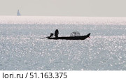 Fisherman on boats fishing with net in the sea. Стоковое видео, видеограф Igor Skripachev / Фотобанк Лори
