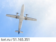 A plane flying through the sky against a blue sky, view from below. The concept of air travel is an airline ticket service. Enjoying the thrill of modern flight as a commercial airplane. Стоковое фото, фотограф Владимир Разгуляев / Фотобанк Лори