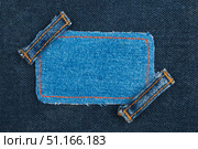 Frame, tag, price  with two straps jeans, lies on the dark denim. Стоковое фото, фотограф Александр Собко / Фотобанк Лори