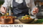 Professional chef carefully garnishing gourmet dish, sprinkling fresh cherry tomatoes and vibrant herbs, elevating culinary presentation with precise, artistic detail. Стоковое AI-видео, аниматор Юрий Поздников / Фотобанк Лори