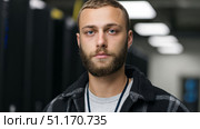 A young IT professional stands confidently in a data center, symbolizing the critical role of technology workers during important Russian public holidays such as Defender of the Fatherland Day (February 23) and Programmer’s Day (September 13). His composed expression and secure server room setting reflect the continuous behind-the-scenes work of system administrators and security experts—even during national celebrations. This image highlights how modern infrastructure and digital systems remain active during festive periods, ensuring stability and connectivity for the entire country. Стоковое AI-изображение, AI-художник Ксения Чунаева / Фотобанк Лори