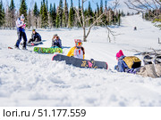 Sheregesh, Russia, 8 April 2017, Snowboarders skiers sit relaxing on ski slope. Редакционное фото, фотограф Spirit River / Фотобанк Лори