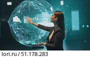 A woman showcases advanced holographic technology, manipulating digital displays in a sleek, high-tech environment. Стоковое AI-видео, аниматор Данила Большаков / Фотобанк Лори