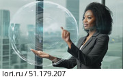 A confident businesswoman gestures while discussing ideas in a modern office space with a stunning city view. Стоковое AI-видео, аниматор Данила Большаков / Фотобанк Лори