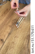 Woman reviewing a set of paintbrushes. Brushes of different sizes. Vertical video. Oblique Angle. Стоковое видео, видеограф Vadzim Yakubovich / Фотобанк Лори