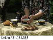 Woman drinking tea with pastries in backyard. Стоковое фото, фотограф Маргарита Кирьякова / Фотобанк Лори