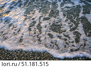 Ocean waves gently lapping against pebbled shore creating serene coastal atmosphere. Стоковое фото, фотограф Наталья Семкина / Фотобанк Лори
