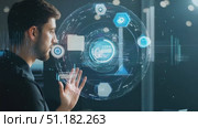A man focuses intently on a high-tech display while reviewing complex data and analytics late in the evening. Стоковое AI-видео, аниматор Данила Большаков / Фотобанк Лори