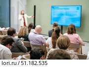 Presenter leads seminar with attendees focusing on business strategies and insights. Стоковое фото, фотограф Антон Гвоздиков / Фотобанк Лори