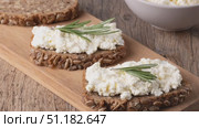 Home made rye bread on a wooden cutting board with curd cheese. Стоковое видео, видеограф Наталия Попова / Фотобанк Лори