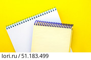 White and beige notepads on a yellow background. Стоковое фото, фотограф Юлия Николаева / Фотобанк Лори