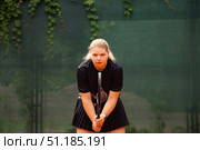 Teenage Girl Focused on Training With Determination on an Outdoor Tennis Court. Стоковое фото, фотограф Aleksandr Golubev / Фотобанк Лори