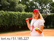 Focused Teenage Girl Perfecting Her Tennis Skills on an Outdoor Court in Bright Sunshine. Стоковое фото, фотограф Aleksandr Golubev / Фотобанк Лори