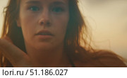 Close view of woman with hair over face during energetically dance at sunset coastline. Стоковое видео, видеограф Ольга Сухарева / Фотобанк Лори