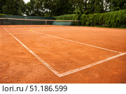 Afternoon Practice Session on a Sun-Kissed Red Clay Tennis Court. Стоковое фото, фотограф Aleksandr Golubev / Фотобанк Лори