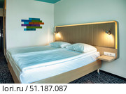 Inviting Guest Room With Colorful Artwork in Quiet Ambience. Стоковое фото, фотограф Aleksandr Golubev / Фотобанк Лори