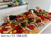 Served table with pastries, vegetables and delicacy meats for coffee break event. Стоковое фото, фотограф Spirit River / Фотобанк Лори