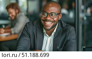 A professional man smiles while seated in a contemporary office, showcasing positivity and engagement during a typical workday. Стоковое AI-видео, аниматор Данила Большаков / Фотобанк Лори