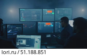 A team of analysts monitors multiple screens displaying crucial data and metrics while responding to an ongoing situation. Стоковое AI-видео, аниматор Данила Большаков / Фотобанк Лори