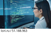 A dedicated programmer is focused on coding at her workstation, surrounded by a high-tech office environment in the afternoon light. Стоковое AI-видео, аниматор Данила Большаков / Фотобанк Лори