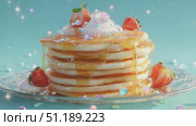 Delicious stack of fluffy pancakes topped with fresh strawberries and whipped cream drizzled with syrup. Стоковое AI-видео, аниматор Ekaterina Ismagilova / Фотобанк Лори