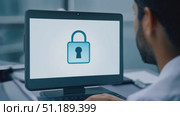 A focused individual engages in a cybersecurity project on a laptop, surrounded by a sleek office environment illuminated by natural light. Стоковое AI-видео, аниматор Данила Большаков / Фотобанк Лори