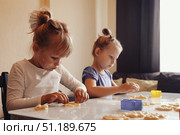 Baking Memories Together in the Cozy Kitchen With Family During a Joyful Cookie-Making Day. Стоковое фото, фотограф Aleksandr Golubev / Фотобанк Лори