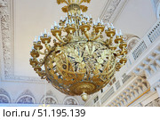 St. Petersburg, Russia - May 27, 2021: Hermitage Museum, large chandelier with gilding for hall lighting. Palace interior details. Редакционное фото, фотограф Наталия Кирсанова / Фотобанк Лори