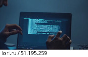 In a darkened space, a person wearing a hood and glasses concentrates on their computer screen, embodying a moment of intense focus and mystery. Стоковое AI-видео, аниматор Данила Большаков / Фотобанк Лори
