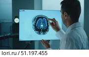A doctor examines a detailed brain scan in a cutting-edge medical facility, emphasizing the importance of technology in patient diagnosis. Стоковое AI-видео, аниматор Данила Большаков / Фотобанк Лори