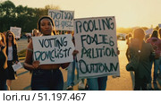 Activists gather in a community rally advocating for voting rights with signs highlighting the importance of participation and representation. Стоковое AI-видео, аниматор Данила Большаков / Фотобанк Лори