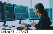 An individual focuses intently on coding while seated at a desk, surrounded by four computer screens displaying complex data. Стоковое AI-видео, аниматор Данила Большаков / Фотобанк Лори