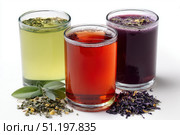 Glasses of tea with different types and colors infused with herbs, on a white background. The teas are green, black, red, purple, and yellow oolong, with loose leaf tea leaves with mint and lavender. Стоковое AI-изображение, AI-художник Марина Демидюк / Фотобанк Лори