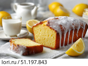 Homemade lemon drizzle cake with icing. Classic lemon pound cake with citrus glaze and zest. Whole loaf, side view, close up. Fresh homemade baked dessert with lemon slices. Blurred tea set background. Стоковое AI-изображение, AI-художник Марина Демидюк / Фотобанк Лори