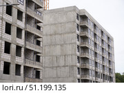 Construction site showing unfinished apartment building with crane in background. construction of a new modern housing complex. Стоковое фото, фотограф Дмитрий Цветков / Фотобанк Лори