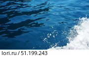 Feel the rush as a boat glides through the calm Adriatic Sea, creating spectacular splashes and vibrant sea foam. Enjoy breathtaking views and the essence of Montenegro Mediterranean charm. Стоковое видео, видеограф Юлия Петровская / Фотобанк Лори