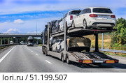 Car transporter truck transports cars along a country road. Стоковое фото, фотограф Юрий Бизгаймер / Фотобанк Лори
