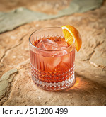 Classic Negroni Cocktail in an Old Fashioned Glass on a Rustic Wooden Surface. Generative AI. Стоковое AI-изображение, AI-художник Roman Zavorotny / Фотобанк Лори