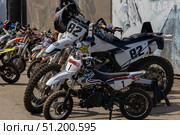 Magnitogorsk, Russian Federation - August 23, 2025: Enduro motorcycles lined up in a competitive setting, showcasing various models and vibrant designs, ready for thrilling races and adrenaline-fueled action. Редакционное фото, фотограф Ирина Ручушкина / Фотобанк Лори