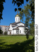 Magnitogorsk, Russian Federation - August 24, 2025: Church of the Intercession of the Most Holy Theotokos with golden dome surrounded by greenery and modern buildings, showcasing architectural beauty and cultural significance. Редакционное фото, фотограф Ирина Ручушкина / Фотобанк Лори