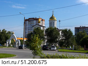 Magnitogorsk, Russian Federation - August 24, 2025: Church of the Intercession of the Most Holy Theotokos with golden domes surrounded by urban landscape and greenery, showcasing architectural beauty and cultural significance. Редакционное фото, фотограф Ирина Ручушкина / Фотобанк Лори