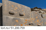 Unique Inca Ashlar polygonal masonry. The ancient wall is made of huge boulders, closely adjacent to each other. Protrusions on the stones surface. Orange lichens. Peru. Cusco. Ollantaytambo. Стоковое фото, фотограф Вера Ивановна Кубарева / Фотобанк Лори