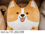 Adorable corgi plush toy displayed among other cute stuffed animals in cozy shop. closeup. Стоковое фото, фотограф ЛУНИНА ВЕРОНИКА / Фотобанк Лори