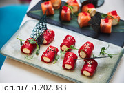 A plate of food with a variety of vegetables and a garnish of black seaweed. The dish is presented on a white plate and is arranged in a visually appealing manner. Стоковое фото, фотограф Наталия Кирсанова / Фотобанк Лори