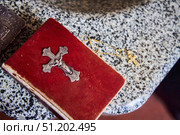A Bible with a large golden cross on the cover. Next to it is a Christian symbol - a cross. The Baptism of man. Стоковое фото, фотограф Наталия Кирсанова / Фотобанк Лори
